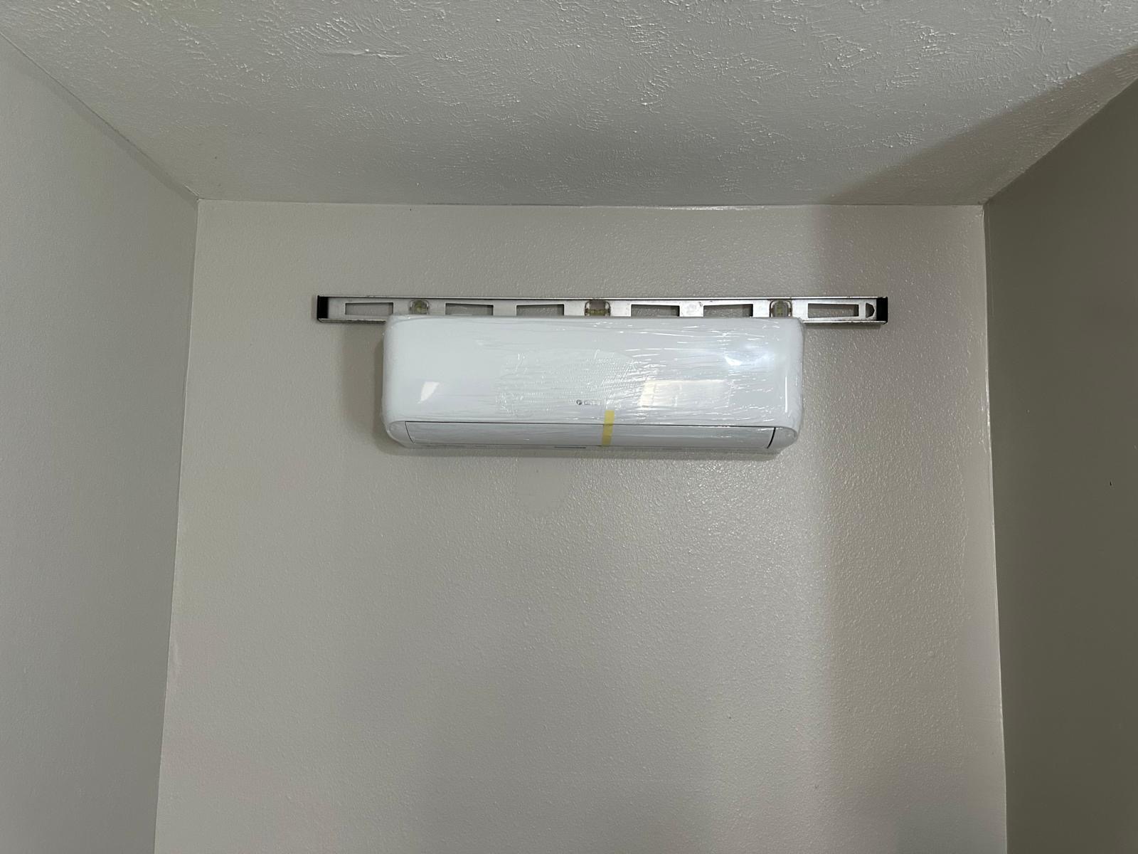 Mini split indoor air handler mounted level on an interior wall